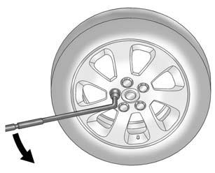 If the wheel has a center cap that covers the lug nuts, place the chisel end of the wheel wrench in each of the slots