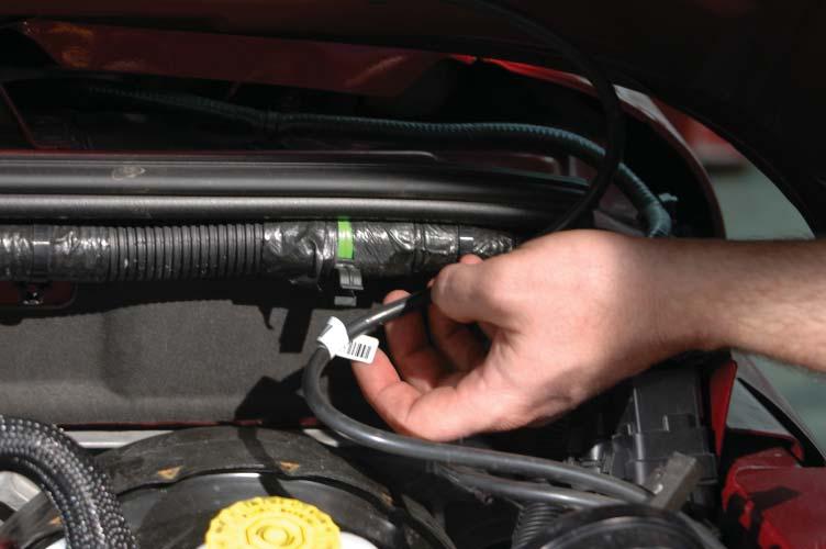 18. Disconnect the windshield washer tube from its connector on the left side of the fi