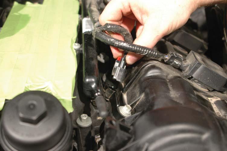 60. Pull up on the fuel injector locking clips, and squeeze the