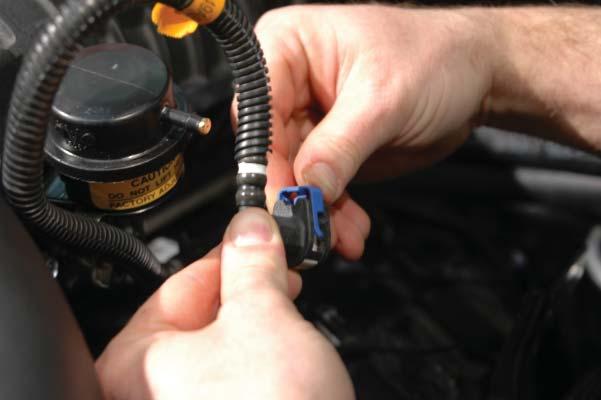 Snip the zip tie holding the belt in shape and Use a ½ drive breaker bar to compress the accessory drive belt