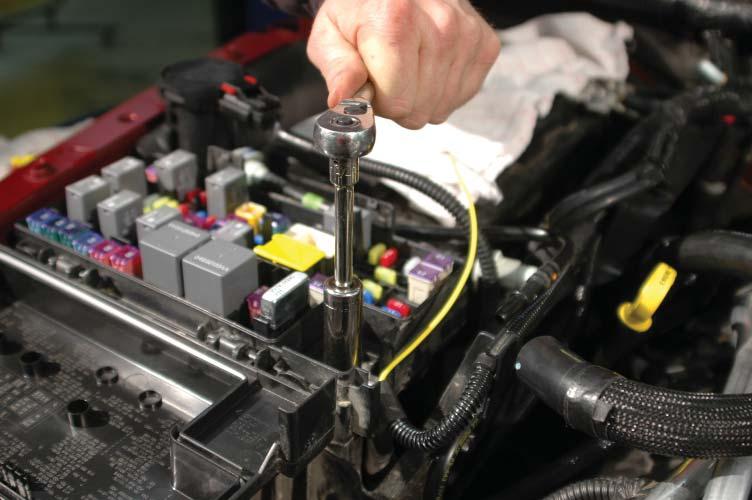 144. Use a 13mm wrench to remove the nut from the hot terminal of the fuse center and replace incorporating