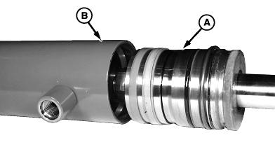 100C External Snap Ring 8. Pull rod assembly (A) from cylinder barrel (B). NOTE: Install rod end in soft-jawed vise in order to remove nut. 25 3 9. Remove nut (C), piston (D) and rod guide (E). 10.