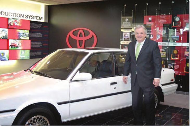 Southern Business & Development owner Mike Randle stands next to the first vehicle built at Toyota Motor Manufacturing Kentucky s plant in Georgetown.