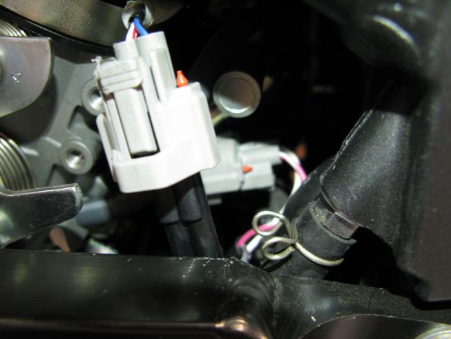 Begin to route the fuel harness back towards the engine, on the left side. Locate the factory INJECTORS, which can be found between the throttle bodies and the frame.