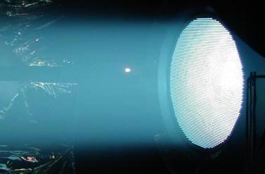 Figure 1. VIPER 56-cm grid-diameter ion thruster. Figure 2. NEXIS Laboratory Model thruster shown producing a well collimated beam from flat grids.