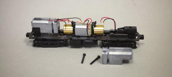 Remove the black plastic clips that secure the track pickup wires and motor wires to the PCB