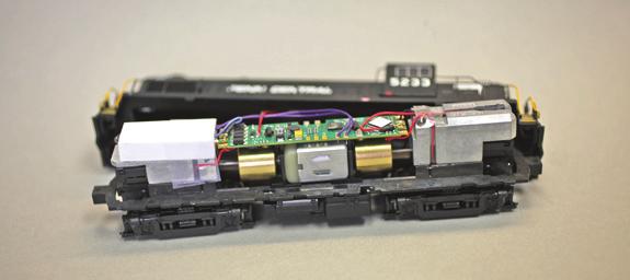 14. Install the TSU-AT1000 decoder by placing it in position on the tabs on top of the motor. Attach track power wires and motor wires to the decoder.