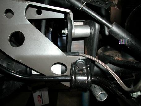 1. Support rear frame with stands. Installing Upper Rear Differential V Link Support 2. Using a jack to support the rear axle, remove the rear factory trac bar from axle and frame.