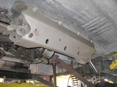 Starting on the left side of the vehicle, line up the forward factory transmission cross-member hole in the bottom of the frame with the hole in the side skid bracket.