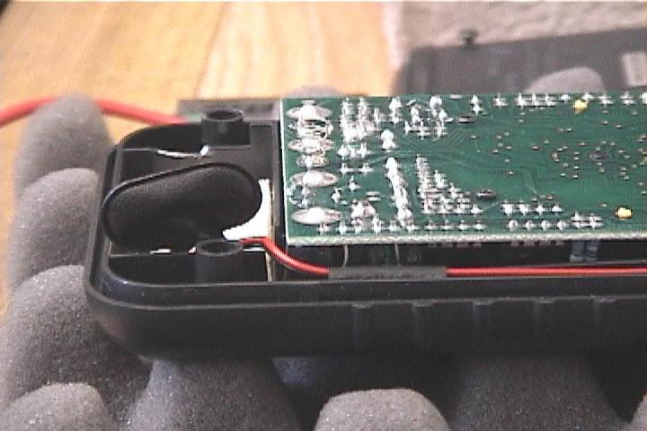 Using both hands, gently guide the board back into the case.