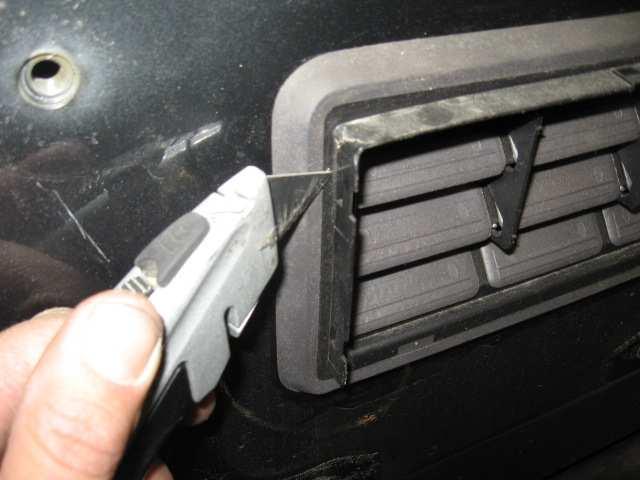 (Fig C) Remove tire carrier and then proceed to carefully trim the edge of the vent.