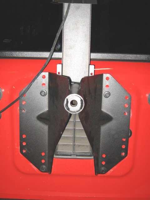 holes. Align the bracket holes to the best hole locations on the tire carrier.