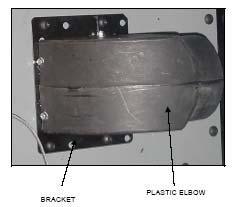 MOUNT THE PLASTIC ELBOW TO THE METAL BRACKET AS SHOWN.