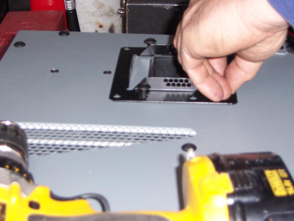 5) Remove the 4 torx screws shown in red to allow clearance for the a/c unit to drop freely into the mounting plate 6) After removing the 4 torx screws the unit can then