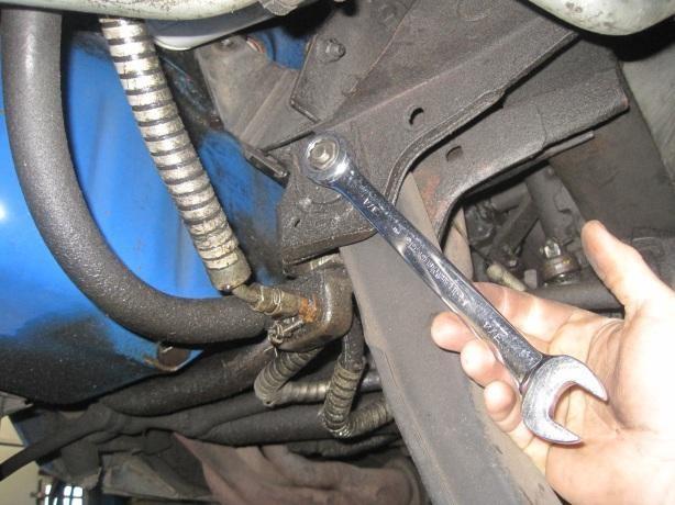 7) Remove the bolt from lower control