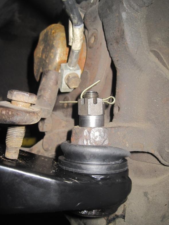 10) Re-install inner lower control bolt and torque to 35-50 lb-ft. 11) Re-install lower control arm ball joint to spindle. 12) Insert supplied aluminum spacer onto ball joint stud.