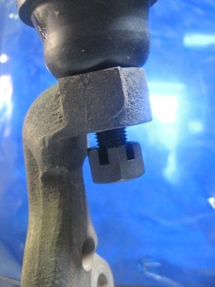 15) Flip the castle nut and screw into the upper control arm ball joint leaving about a ¼ gap from the spindle to the castle nut. a. Doing this will protect the threads of the ball joint when loosening the ball joint from the spindle.