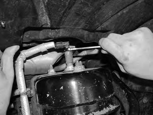 20. Support the lower control arm with a hydraulic jack. First remove the air line from the fitting followed by the three air spring to frame mounting nuts (Fig 7). 21.