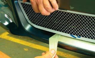 Align the lower mesh grille asembly into place and begin securing it with the supplied large