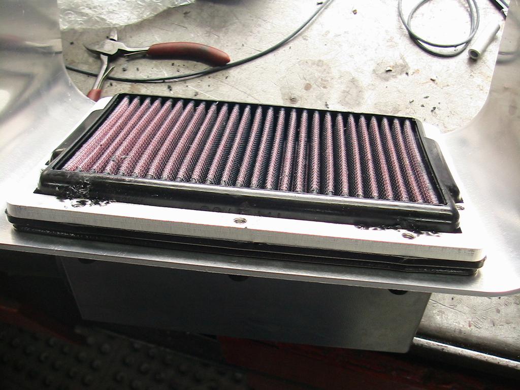 Install plenum box assembly with air filter onto throttle body, using the 4 oem velocity stacks