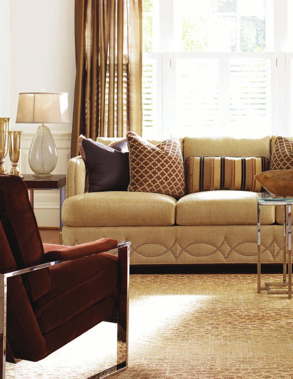 The Elizabeth sofa features a graceful pattern of decorative nailhead trim on the base, continuing around