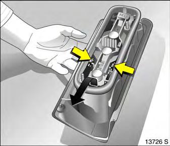 5. Press retaining lugs on bulb mounting together and remove bulb mounting, as shown in illustration.