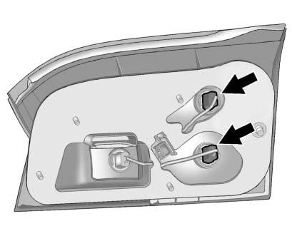 . 2. Remove the interior trim access panel. 3. Remove the five attachment nuts (1) securing the taillamp assembly to the liftgate.