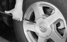 3. Tilt the retainer at the end of the cable when the tire has been completely lowered, and pull it through the wheel opening. Pull the tire out from under the vehicle.