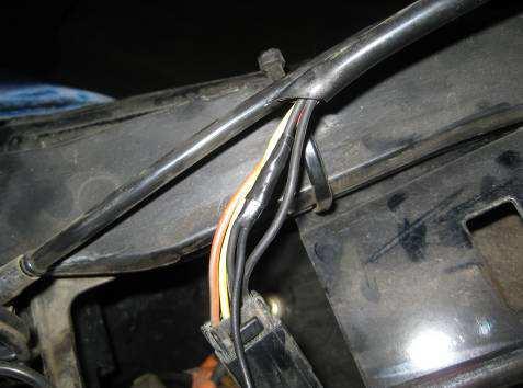 Locate the three or four wire harness going to the fuel pump and fuel sender connector near the gas cap (shown below).