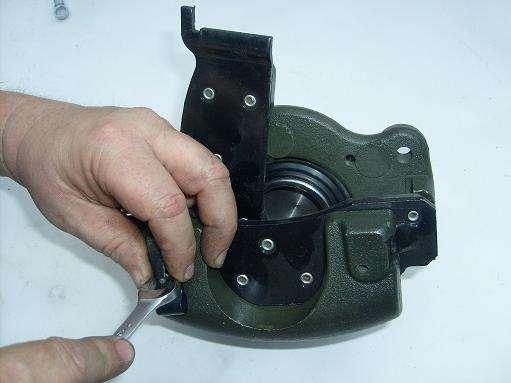 20. Install the outboard brake pads onto their caliper using the pins and clips shown in the series of images below.