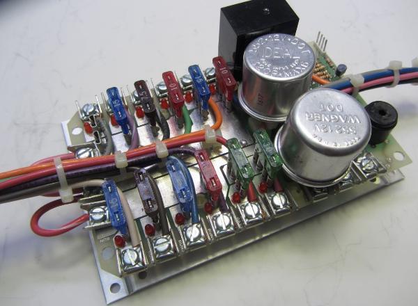 It also features replaceable lugless connectors. Fuses are grouped in three pairs of 4 one for "Bat", "Accy" and "Run" key positions. Model 1430 Fusing sub panel with blown fuse alarm system built in.