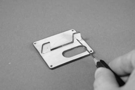 Remove the servo cover from the wing by removing the four 2mm x 12mm sheet metal screws using a #1 Phillips screwdriver.