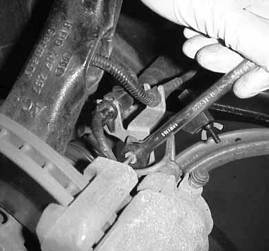 7.Using an 11mm wrench, disconnect brake line from caliper.