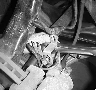 13.Using a deep well socket, remove the 17mm bolts on the back side of the caliper and
