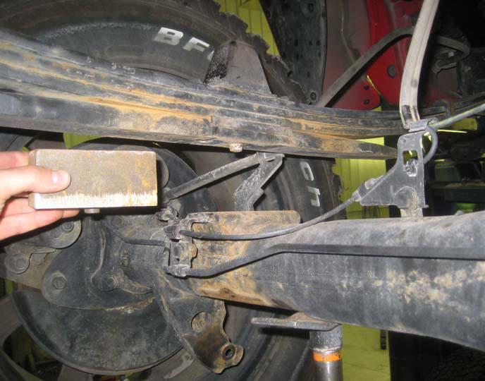 To begin installation, block the front tires of the vehicle so that the vehicle is stable and cannot roll. Safely lift the rear of the vehicle and support the frame with jack stands.