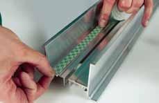 4. Starting on one end of a track section, unroll the mounting tape as close to the inside rails as possible so the