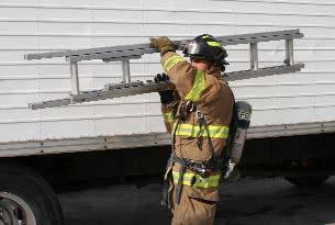 Firefighter positioned at the balance point of the ladder with right hand on bottom beam and left hand on top beam. 3.