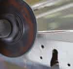 Grinding Use grade 0 fiber-backed abrasive disc to grind outer edge and separate door skin from door frame.