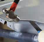 Use a putty knife to help separate skin from adhesive and NVH material on intrusion beam.