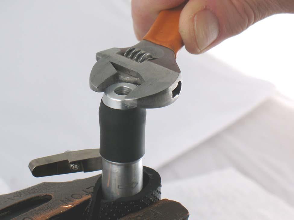 3. Use a piece of rubber to protect housing and fasten in vise with aluminum or