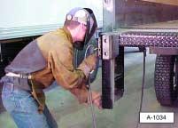 Tip: Place a wet shop towel or rag around the switch box control cable when welding the curbside dock bumper