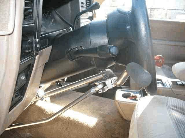 The Ford Bronco was equipped with push/pull lever operated foot controls and a steering wheel spinner knob (Figures 3-5).