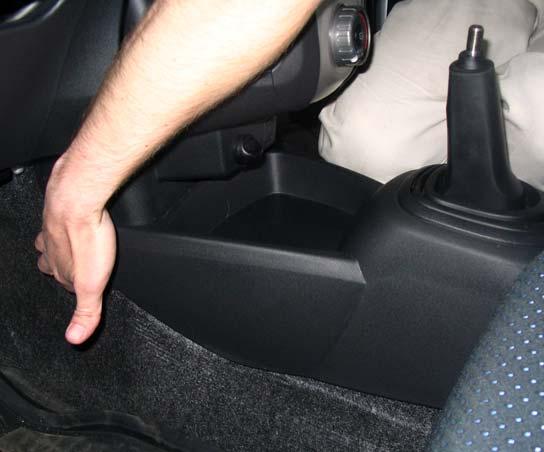 3. Carefully lift the front of the console, there is a clip on