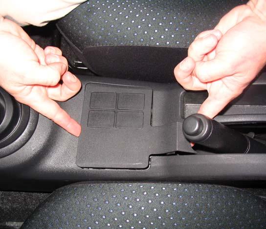 Lift up and remove the center portion of the console in front