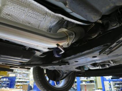 5. With the connection to the downpipe loose, carefully remove the front portion of the stock exhaust by pulling the hanger rods out of the rubber bushings.