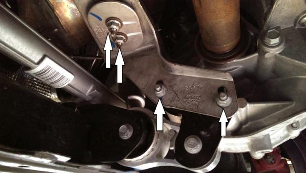 14. Moving under the car, raise the car up on jack stands or on the lift. Using a 13mm socket, remove the four (4) nuts that hold the bracket that connects the downpipe to the transmission. 15.
