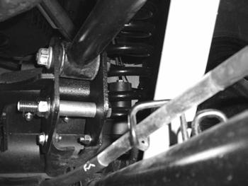 Attach relocation brackets with 3/8 x 1-1/4 bolts, washers, and nuts. The inside passenger hole will require the 8mm bolt and the tab on the e-brake cable bracket to be formed slightly for clearance.