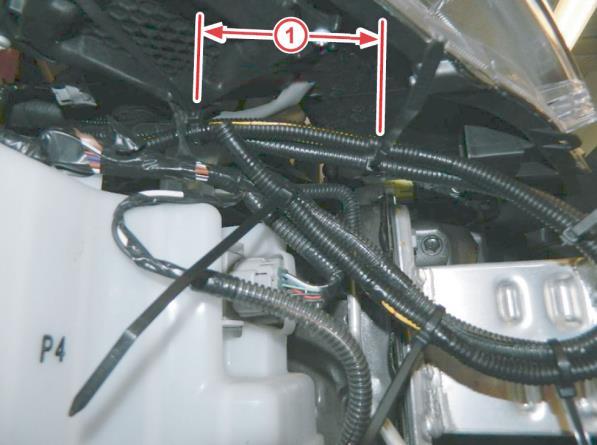Six tie wraps are needed for the driver side. (4) Trim the nylon ties AFTER installation. Nylon Ties Front of Vehicle Figure 3. 8. Reinstall the bumper cover.