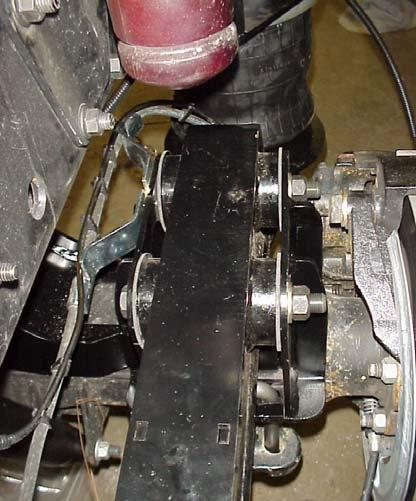 Fasten the FRONT HANGER to the frame using (6) 1/2 x 1 3/4 UNC FLANGE BOLTS and (6) 1/2 UNC TOP LOCK FLANGE NUTS, supplied with kit. See Fig. 5-1, 5-2. (See Table 10-1 for appropriate Torque). 3. Position the DRIVER SIDE TRAILING ARM on top of the LOWER LATERAL CONTROL BRACKET as shown in Fig.