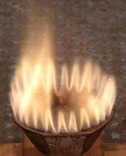 The flame in the center photo of Figure A.1 is fueled by ammonia with adequate hydrocarbon input, and produces very little or no odor.